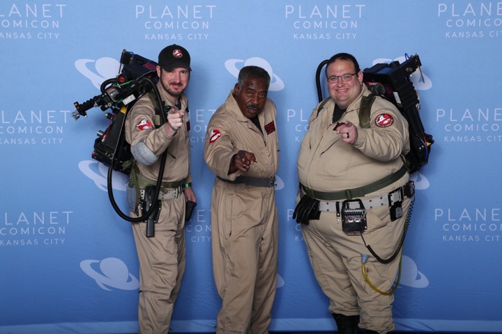 Ghostbusters fans in flight suits posing at Planet Comicon Kansas City.